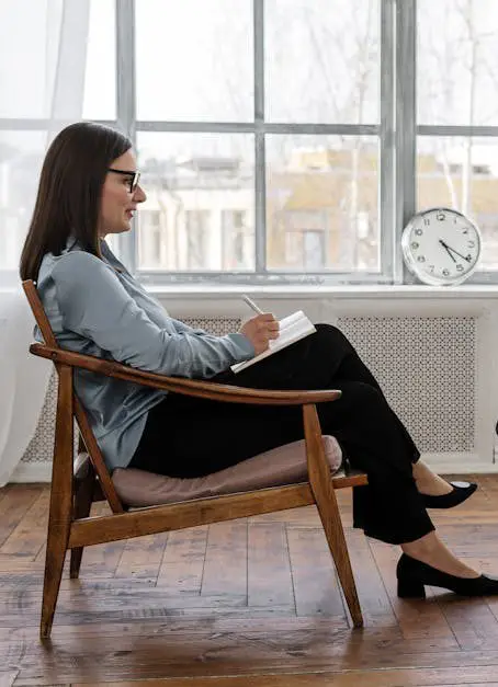 A therapist engaging in a counseling session with a male patient to support mental health.